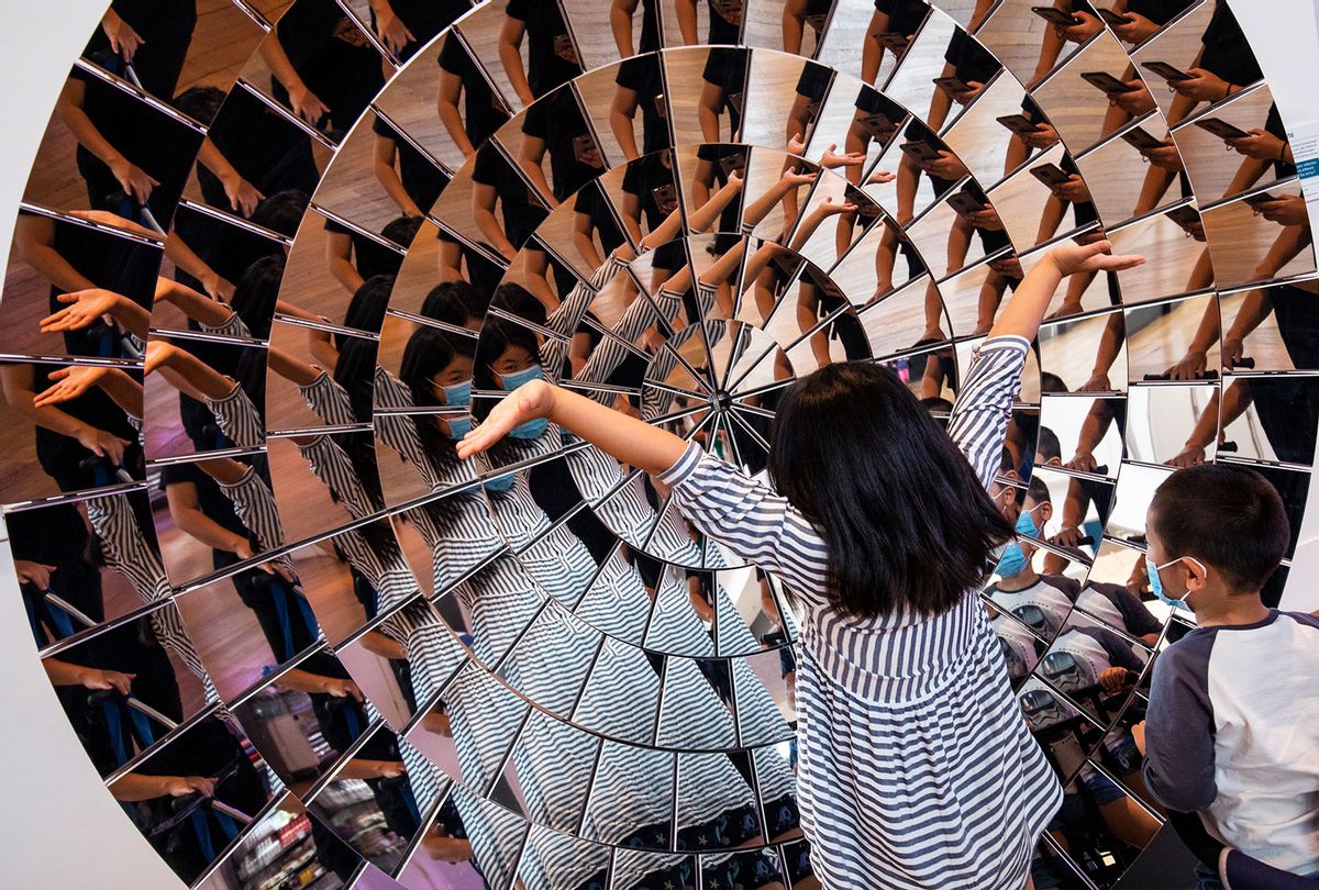 Children play in a large mirrored object at the Science Museum on it's official re-opening day on August 19, 2020 in London, England. The Science Museum reopens its doors to the public today, nearly five months after the Coronavirus pandemic shut down all public spaces. (Dan Kitwood/Getty Images)