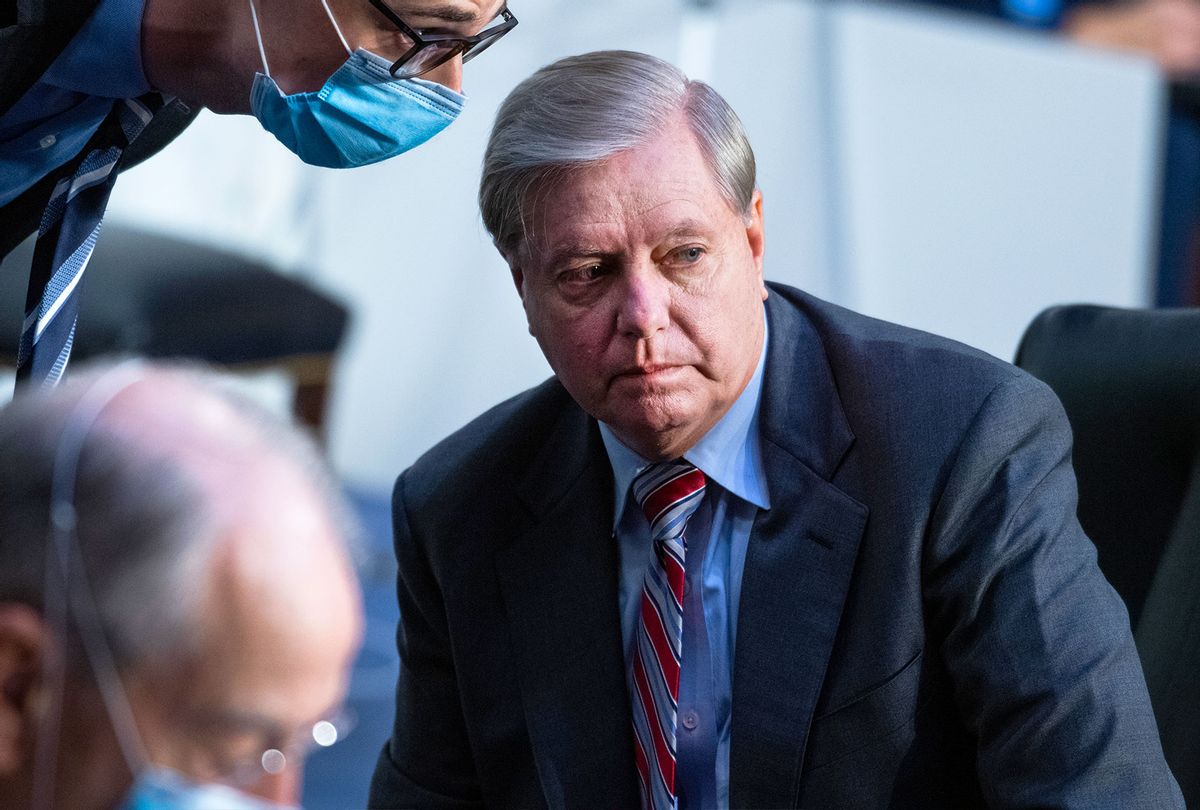 Chairman Sen. Lindsey Graham (R-SC) listens to an aide on the fourth day of the Supreme Court confirmation hearing for nominee Judge Amy Coney Barrett before the Senate Judiciary Committee on Capitol Hill on October 15, 2020 in Washington, DC. (Tom Williams-Pool/Getty Images)