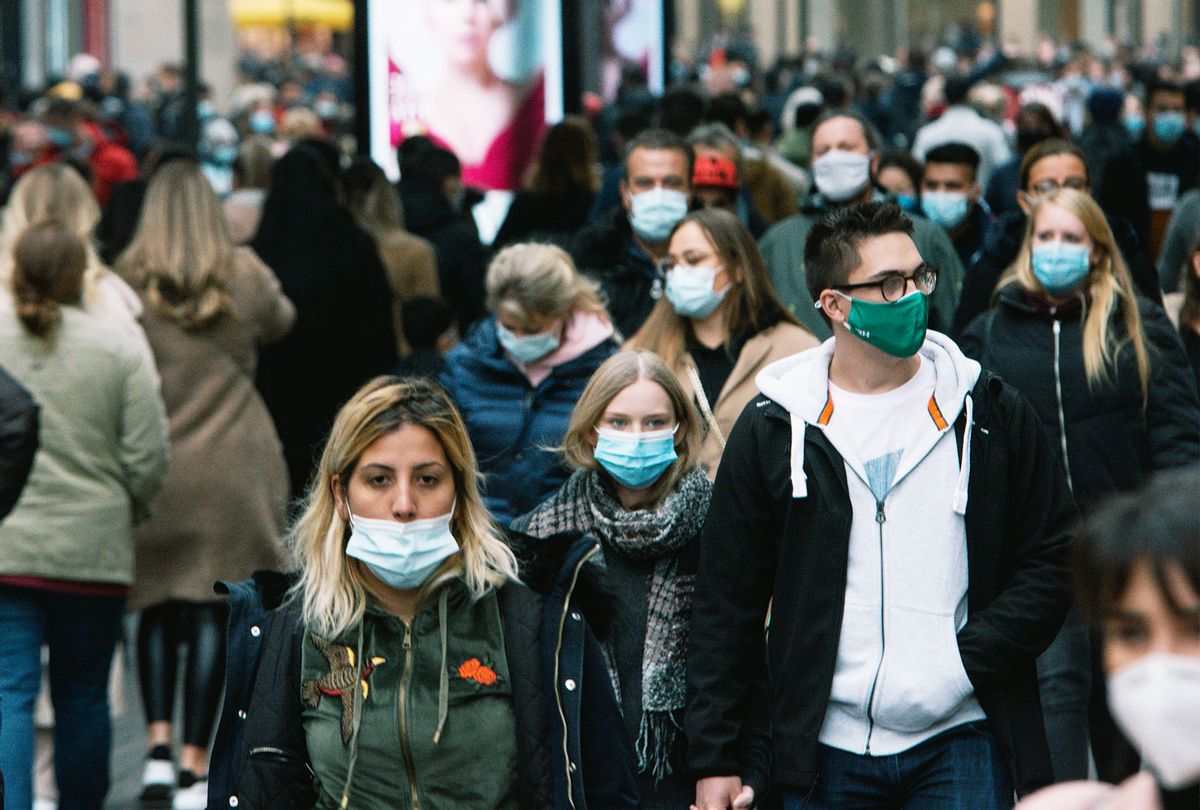 Crowd of people with face masks walking in the shopping block in Cologne, Germany, on October 17, 2020 as NRW state mandate face covering in most of city center areas (Ying Tang/NurPhoto via Getty Images)