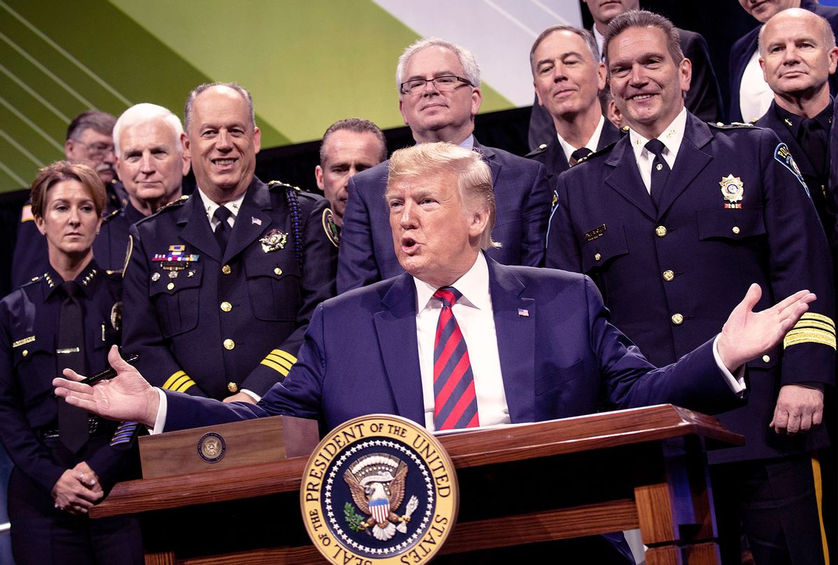 US President Donald Trump pauses while signing an executive order during the International Association of Chiefs of Police Annual Conference and Exposition at the McCormick Place Convention Center October 28, 2019, in Chicago, Illinois. (BRENDAN SMIALOWSKI/AFP via Getty Images)