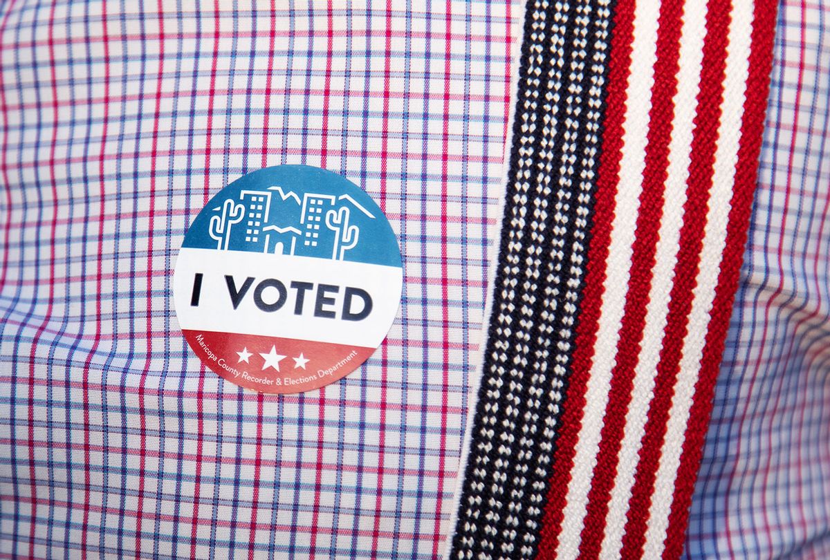 An I voted sticker is placed on Eddie Slade's shirt at Burton Barr Central Library on November 3, 2020 in Phoenix, Arizona. After a record-breaking early voting turnout, Americans head to the polls on the last day to cast their vote for incumbent U.S. President Donald Trump or Democratic nominee Joe Biden in the 2020 presidential election. (Courtney Pedroza/Getty Images)
