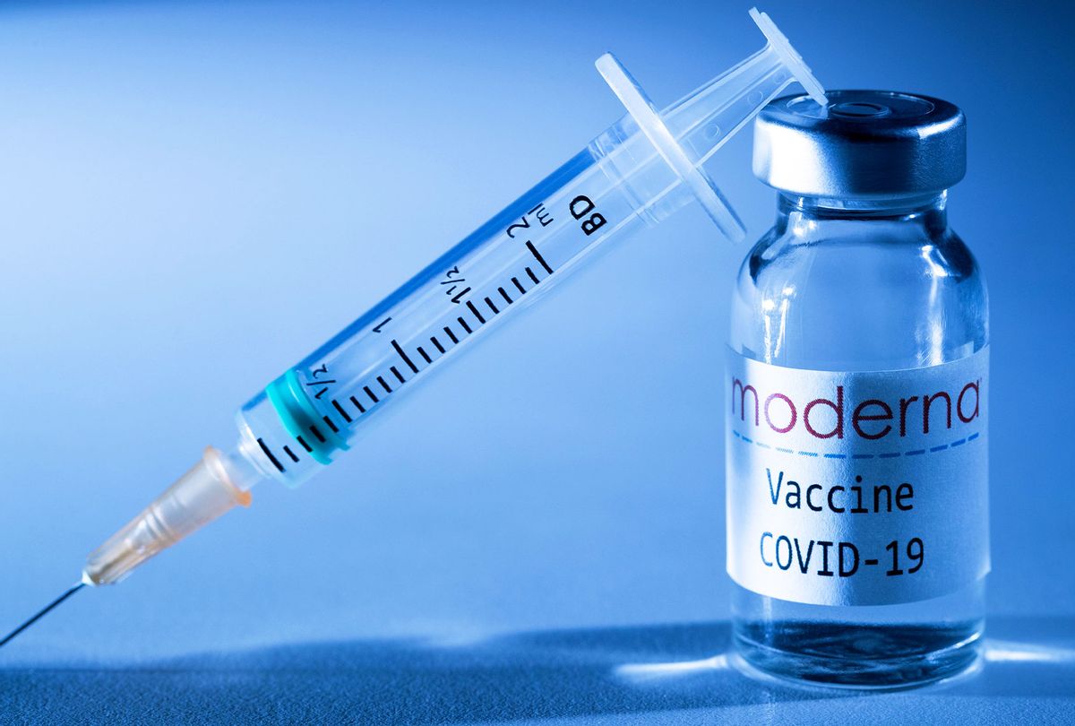 This creative image taken in a studio in Paris on November 16, 2020, showing a syringe and a vaccine vial with the reproducted logo of a US biotech firm Moderna (JOEL SAGET/AFP via Getty Images)