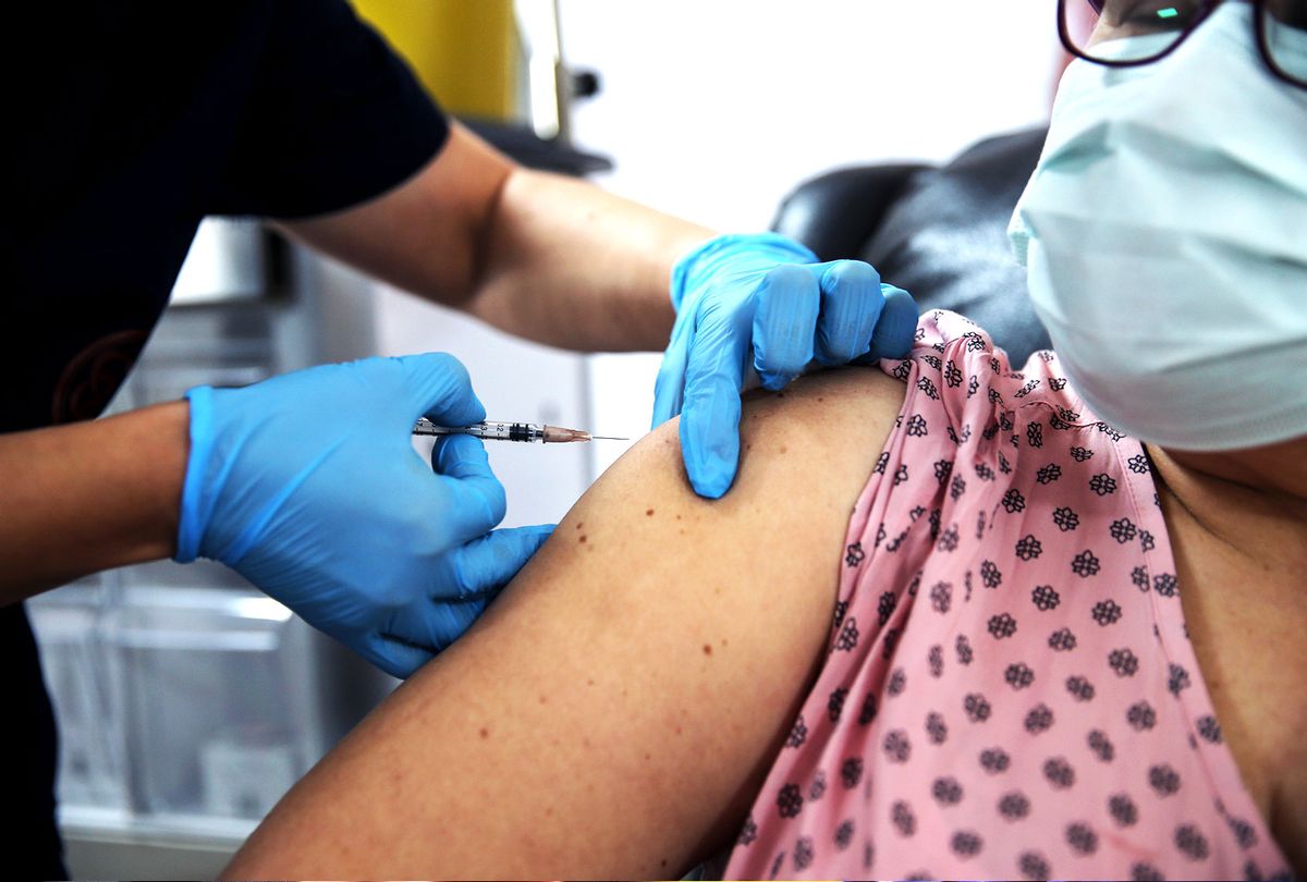 A health care worker injects the a syringe of the phase 3 vaccine trial, to a volunteer at the Ankara University Ibni Sina Hospital in Ankara, Turkey on October 27, 2020. This vaccine candidate developed against the novel coronavirus (COVID-19) pandemic by the U.S. Pfizer and German BioNTech company. (Dogukan Keskinkilic/Anadolu Agency via Getty Image)