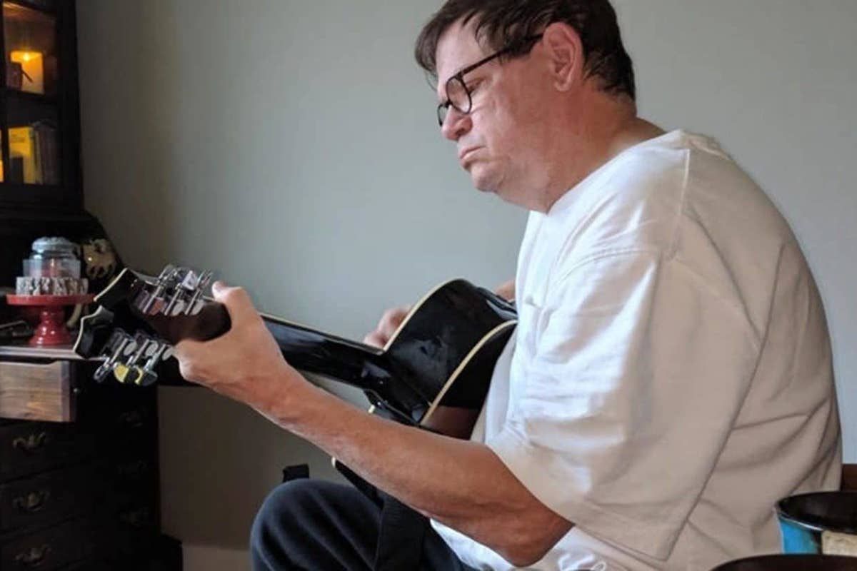Tenino, Washington police chief Bob Swain playing guitar at home in June. Earlier in the year he was told his kidneys were failing and dialysis was necessary. But he had other plans. (Larry C. Price)
