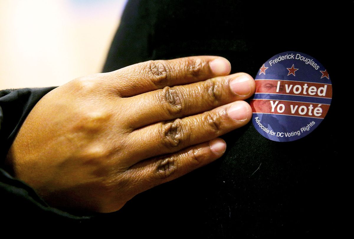 A voter wears a bilingual I voted sticker at the University of the District of Columbia (UDC) during early voting in the 2020 US presidential election. (Yegor Aleyev\TASS via Getty Images)