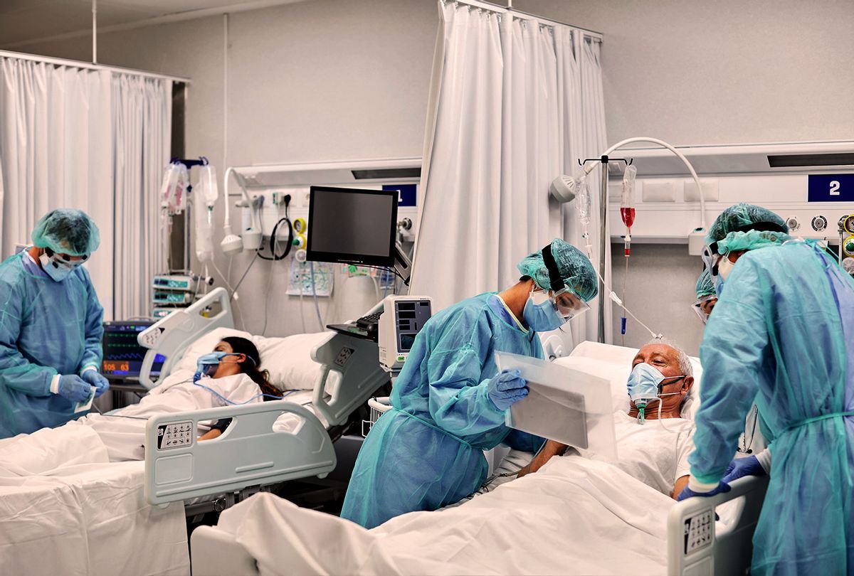 Doctors and nurses taking care of patients in ICU at hospital during COVID-19 (Getty Images)