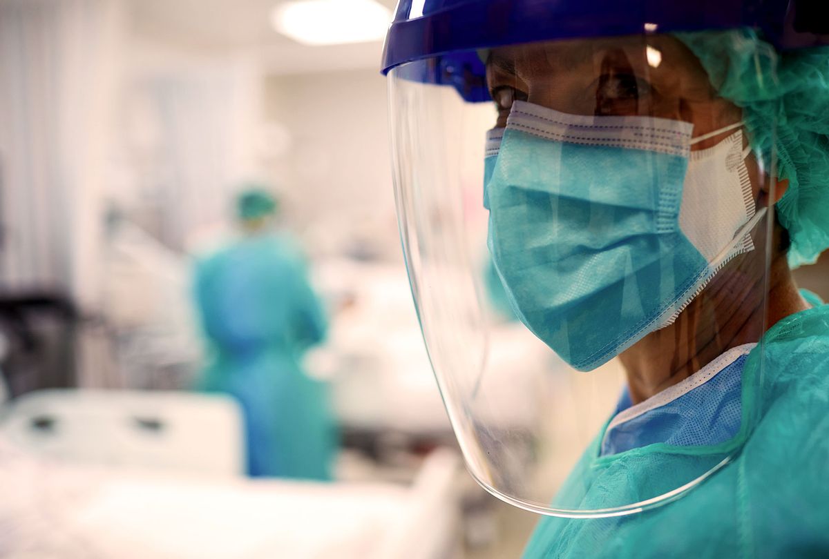 Close up view of a doctor wearing surgical mask and a face shield in a hospital COVID ward. (Getty Images)