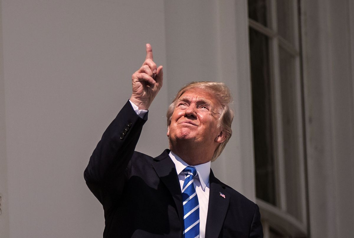 President Donald Trump looks up toward the Solar Eclipse with out glasses from a balcony at the White House in Washington, DC on Monday, Aug 21, 2017. (Jabin Botsford/The Washington Post via Getty Images)