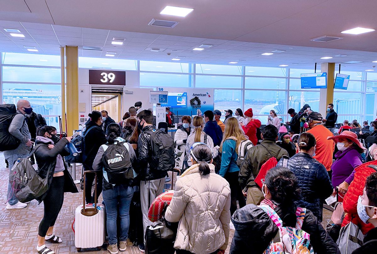Crowds seen, on December 18, 2020 at Washington Reagan National Airport (DCA) with long queues at the Departure gates in Arlington, Virginia, as the Christmas holiday travel starts despite the Coronavirus pandemic. (DANIEL SLIM/AFP via Getty Images)