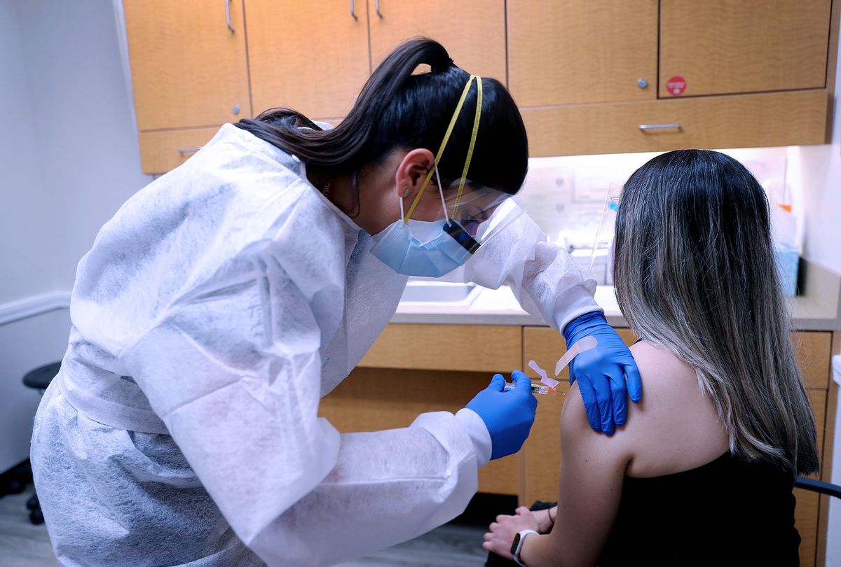 Nurse Practitioner wears personal protection equipment as she administers a flu vaccination  (Getty Images)