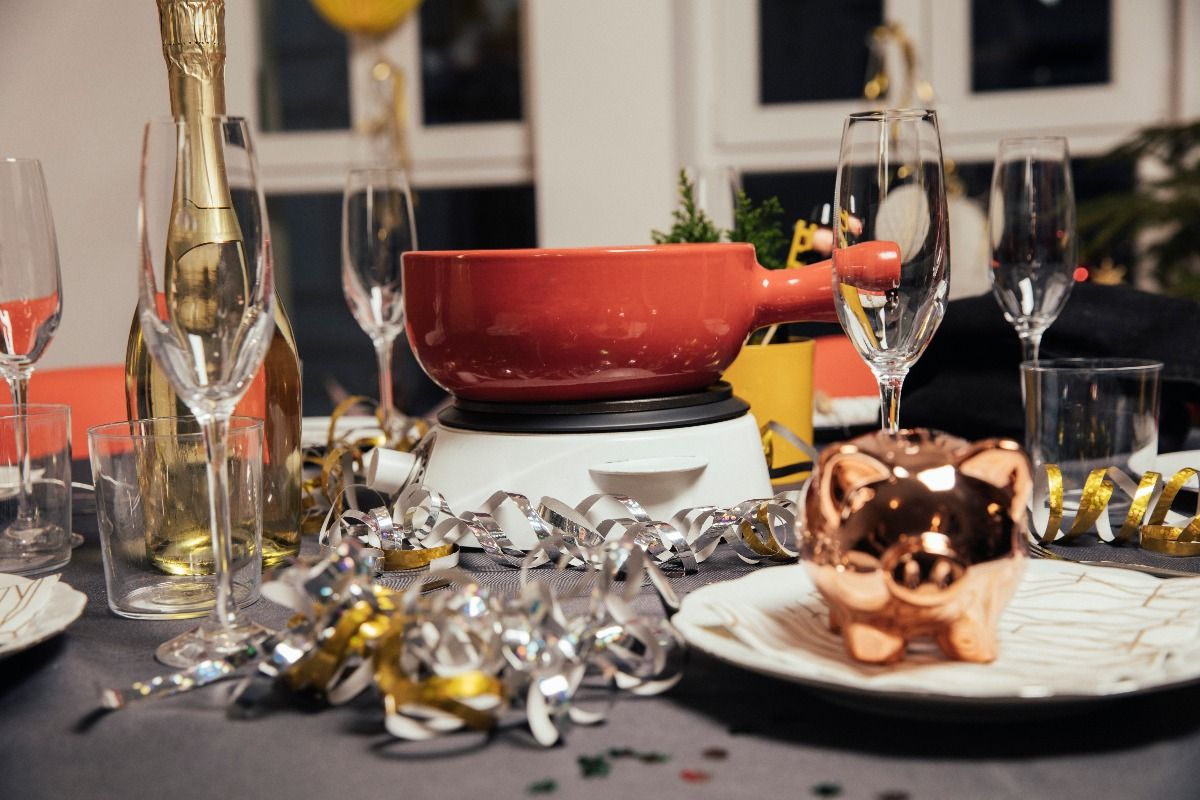 Laid table with cheese fondue for a New Year's Eve party. (Getty Images)