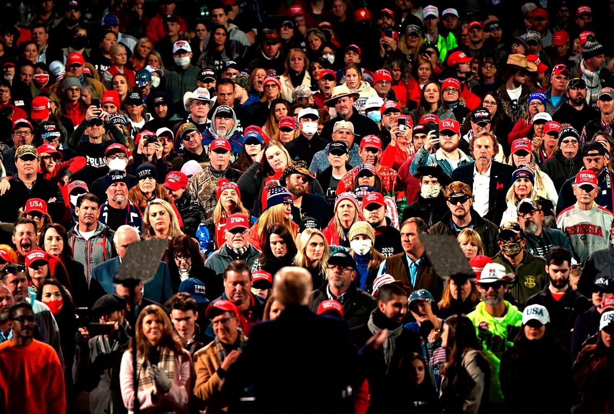 Supporters - most of them not wearing masks in the middle of a global pandemic - listen as US President Donald Trump speaks at a rally to support Republican Senate candidates at Valdosta Regional Airport in Valdosta, Georgia on December 5, 2020. (ANDREW CABALLERO-REYNOLDS/AFP via Getty Images)