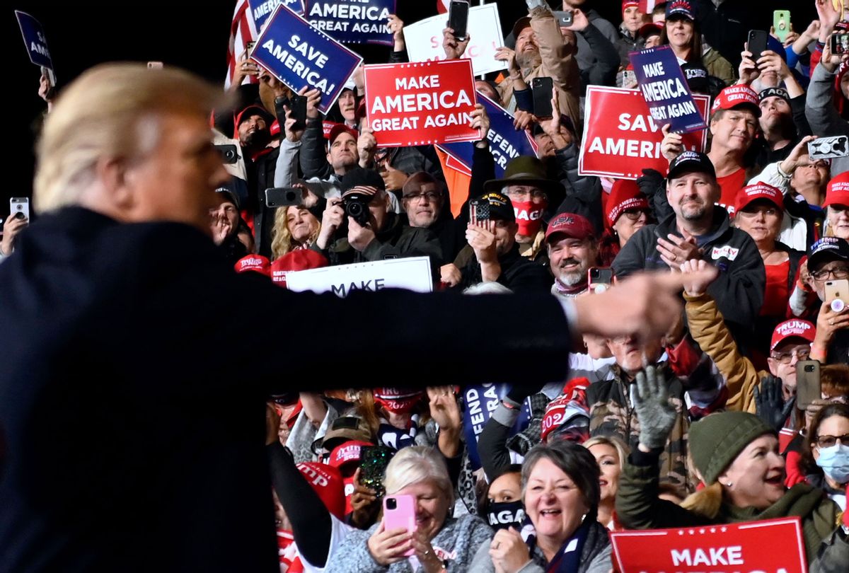 Supporters cheer as US President Donald Trump gestures after speaking during a rally to support Republican Senate candidates at Valdosta Regional Airport in Valdosta, Georgia on December 5, 2020. (ANDREW CABALLERO-REYNOLDS/AFP via Getty Images)