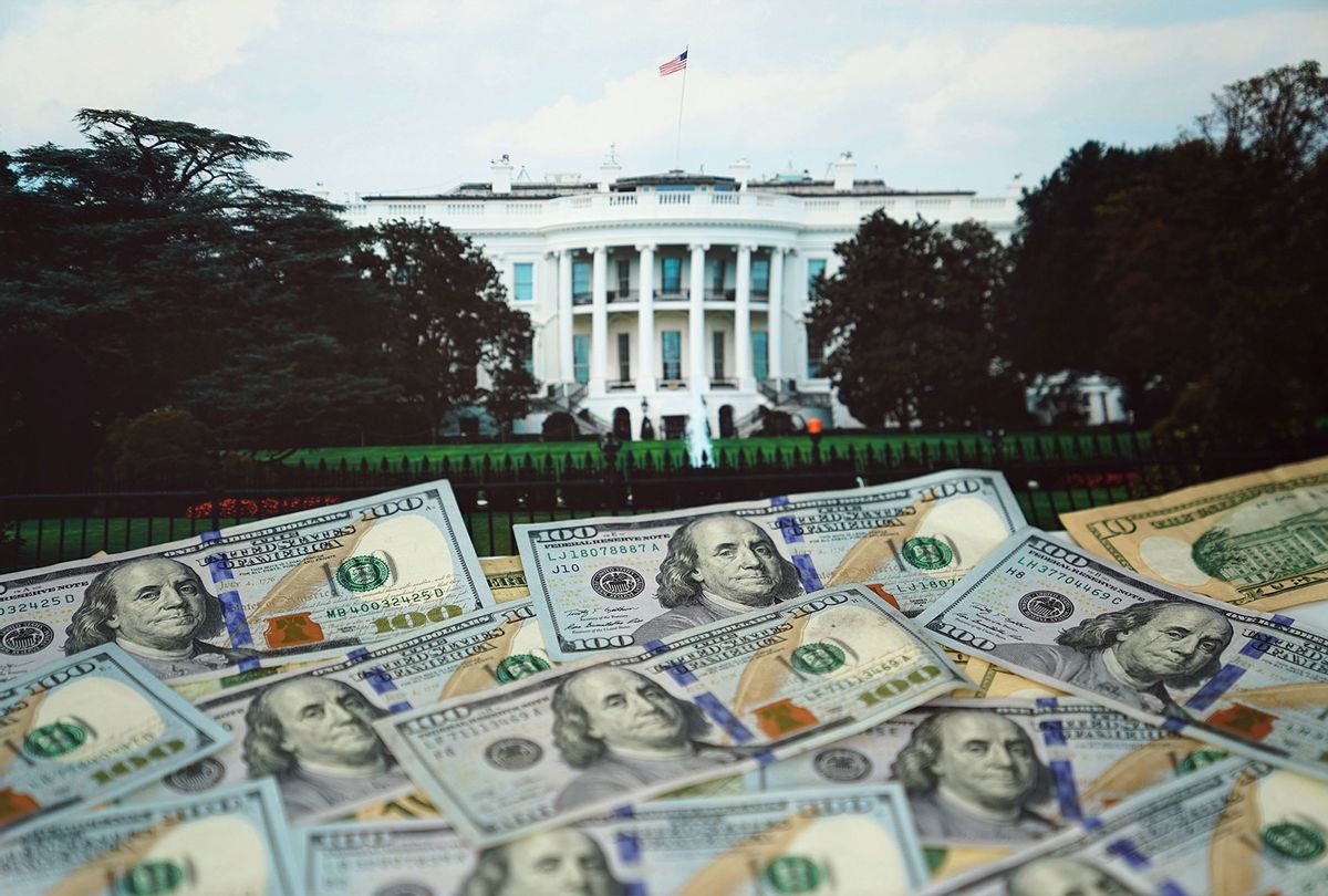U.S. dollar banknotes and an image of White House (Getty Images)