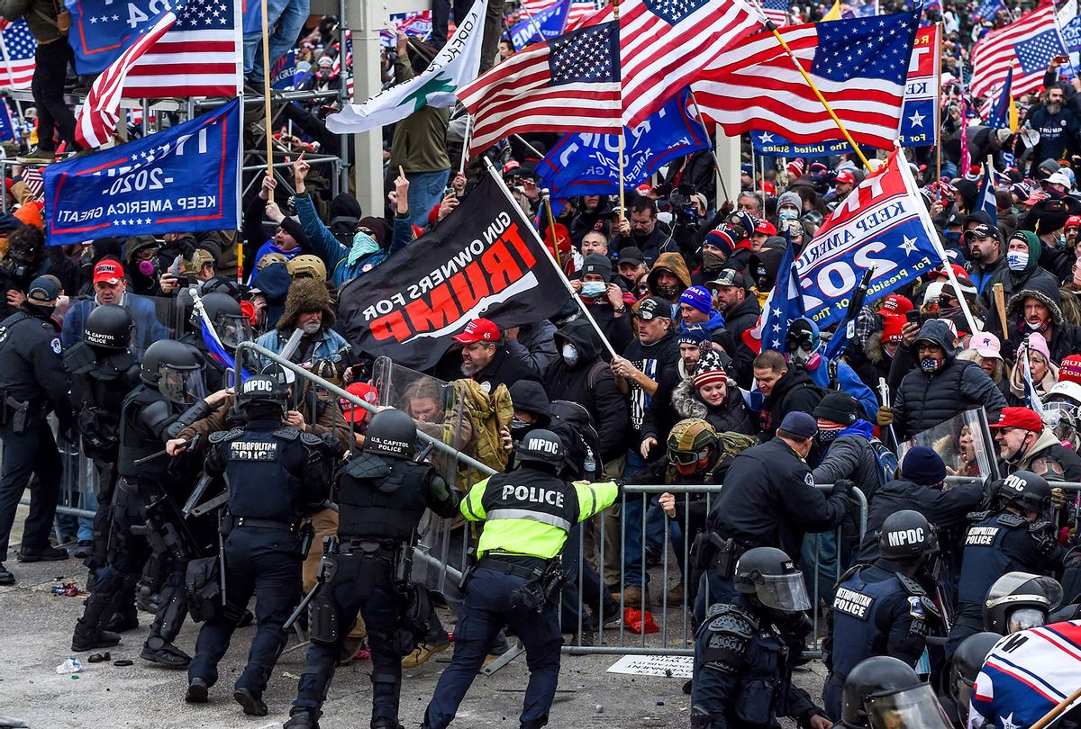 Trump supporters clash with police and security forces as they storm the US Capitol in Washington, DC on January 6, 2021. - Demonstrators breeched security and entered the Capitol as Congress debated the a 2020 presidential election Electoral Vote Certification. (ROBERTO SCHMIDT/AFP via Getty Images)