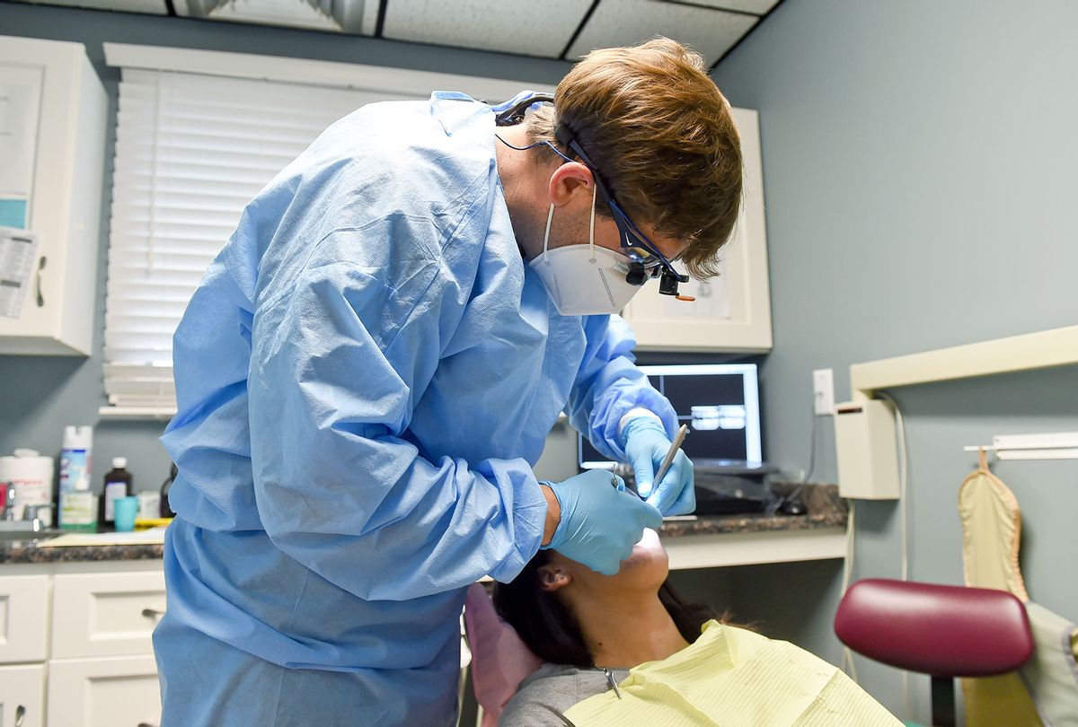 Dr. Jordan Hottenstein checks a patient's teeth. At Central Berks Dental Center in Leesport Tuesday afternoon October 13, 2020. (Ben Hasty/MediaNews Group/Reading Eagle via Getty Images)