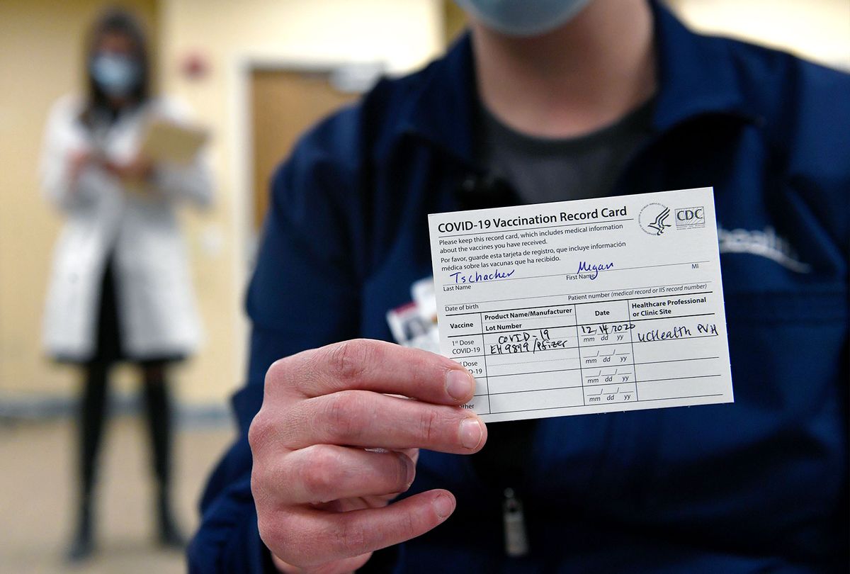 Poudre Valley Hospital ICU Nurse Megan Tschacher shows off her vaccination card after getting the first round of Covid-19 vaccines at UC Health Poudre Valley Hospital on December 14, 2020 in Fort Collins, Colorado. The first Covid-19 vaccines were administered in Colorado to frontline health care workers in Fort Collins and Colorado Springs today.  (Helen H. Richardson/MediaNews Group/The Denver Post via Getty Images)