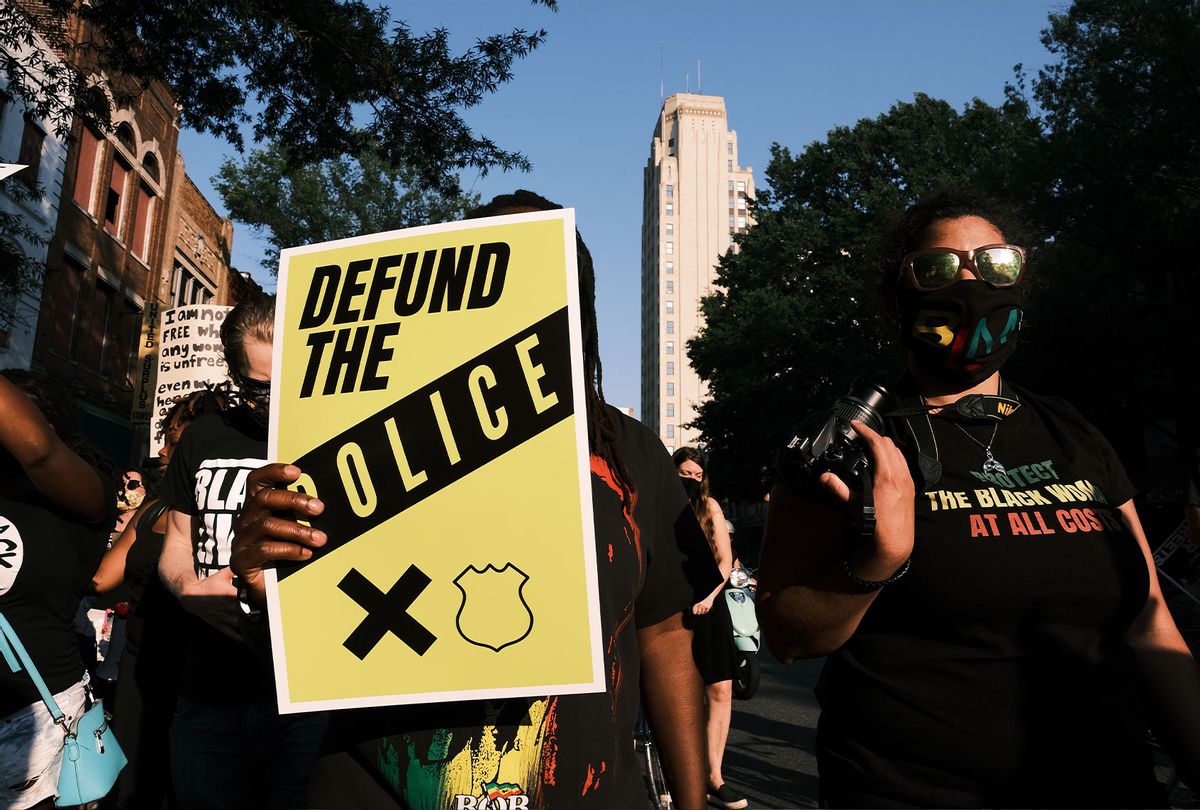 A protester carries a sign that reads "Defund The Police" during the Black Women Matter "Say Her Name" march on July 3, 2020 in Richmond, Virginia. Protests continue around the country after the death of African Americans while in police custody. (Eze Amos/Getty Images)