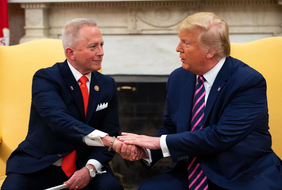 U.S. Rep. Jeff Van Drew of New Jersey, who has announced he is switching from the Democratic to Republican Party, shakes hands with U.S. President Donald Trump in the Oval Office of the White House on December 19, 2019 in Washington, DC. Van Drew voted against the two articles of impeachment yesterday in the House of Representatives. (Drew Angerer/Getty Images)