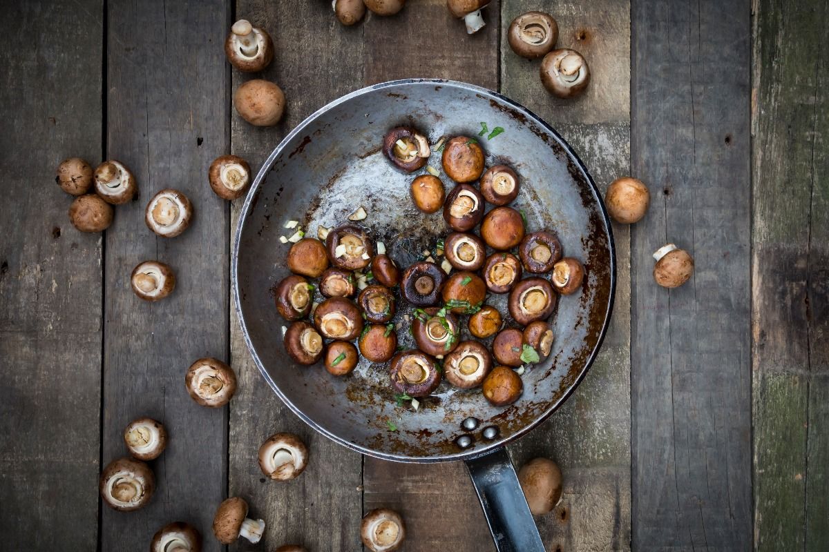 Crimini mushrooms with garlic and basil in pan, braised  (Getty Images)