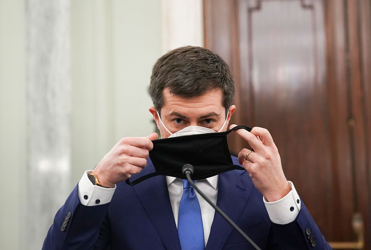 Pete Buttigieg, U.S. secretary of transportation nominee for U.S. President Joe Biden, puts on a protective mask during a Senate Commerce, Science and Transportation Committee confirmation hearing on January 21, 2021 in Washington, D.C. Buttigieg, is pledging to carry out the administration’s ambitious agenda to rebuild the nation’s infrastructure, calling it a “generational opportunity” to create new jobs, fight economic inequality and stem climate change. (Stefani Reynolds - Pool/Getty Images)