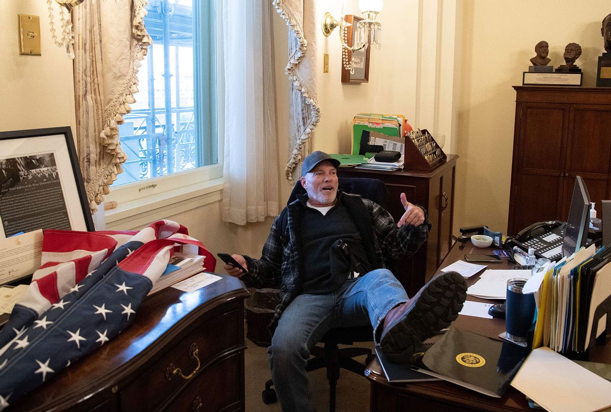 Richard Barnett, a supporter of US President Donald Trump sits inside the office of US Speaker of the House Nancy Pelosi as he protest inside the US Capitol in Washington, DC, January 6, 2021. - Demonstrators breeched security and entered the Capitol as Congress debated the a 2020 presidential election Electoral Vote Certification. (SAUL LOEB/AFP via Getty Images)