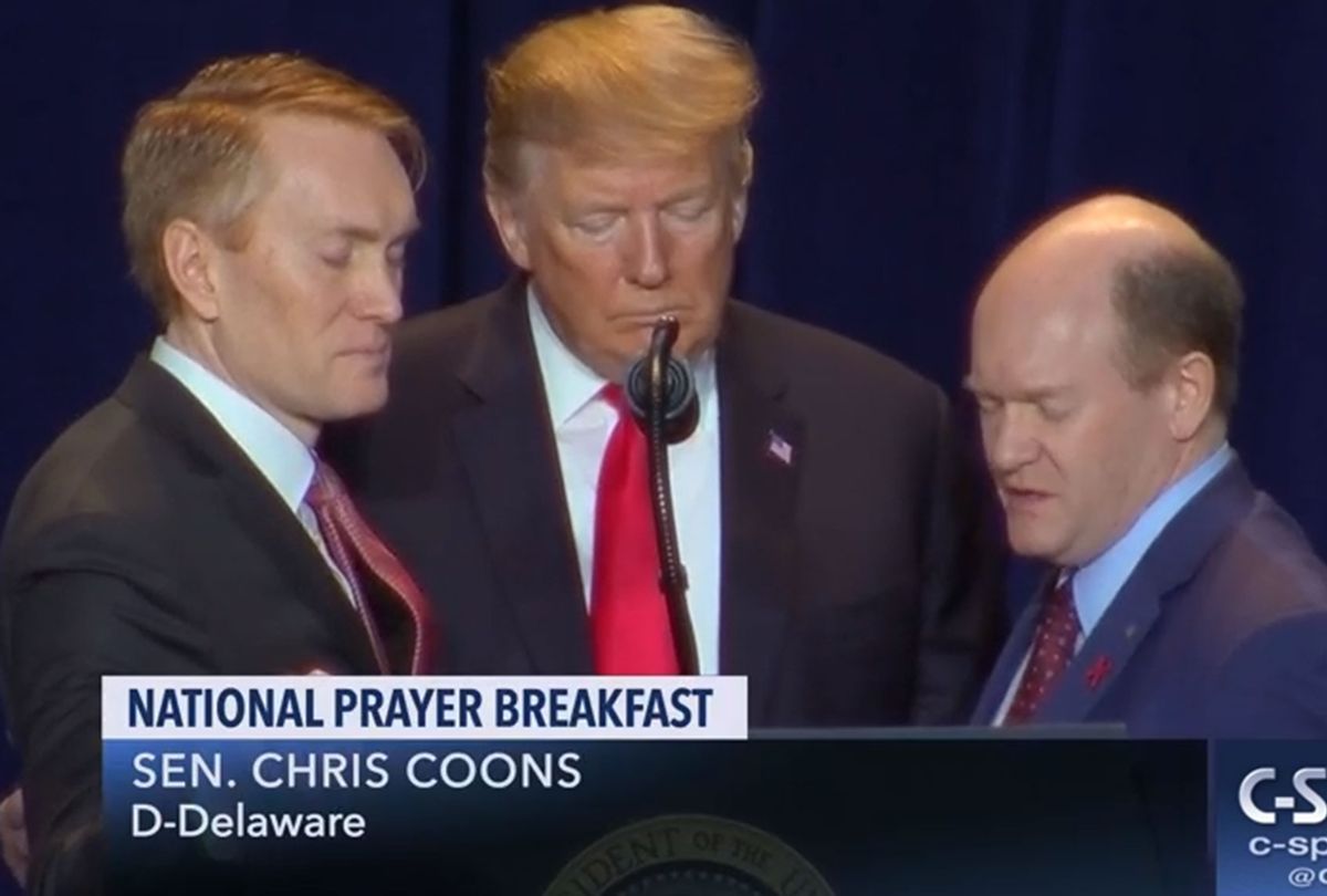 Pres. Trump at the 2019 National Prayer Breakfast, with co-chairs Sen. James Lankford (R-OK), who objected last week to electoral-vote counting, and, on the right, Sen. Chris Coons (D-DE). (Screengrab from C-SPAN video)