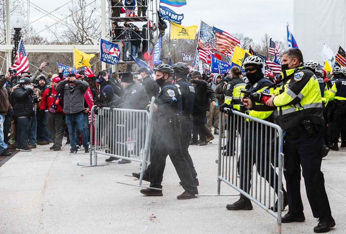 A large group of pro-Trump protesters face off against police with pepper spray after protesters storm the grounds of the Capitol Building on January 6, 2021 in Washington, DC. A pro-Trump mob stormed the Capitol, breaking windows and clashing with police officers. Trump supporters gathered in the nation's capital today to protest the ratification of President-elect Joe Biden's Electoral College victory over President Trump in the 2020 election. (Jon Cherry/Getty Images)