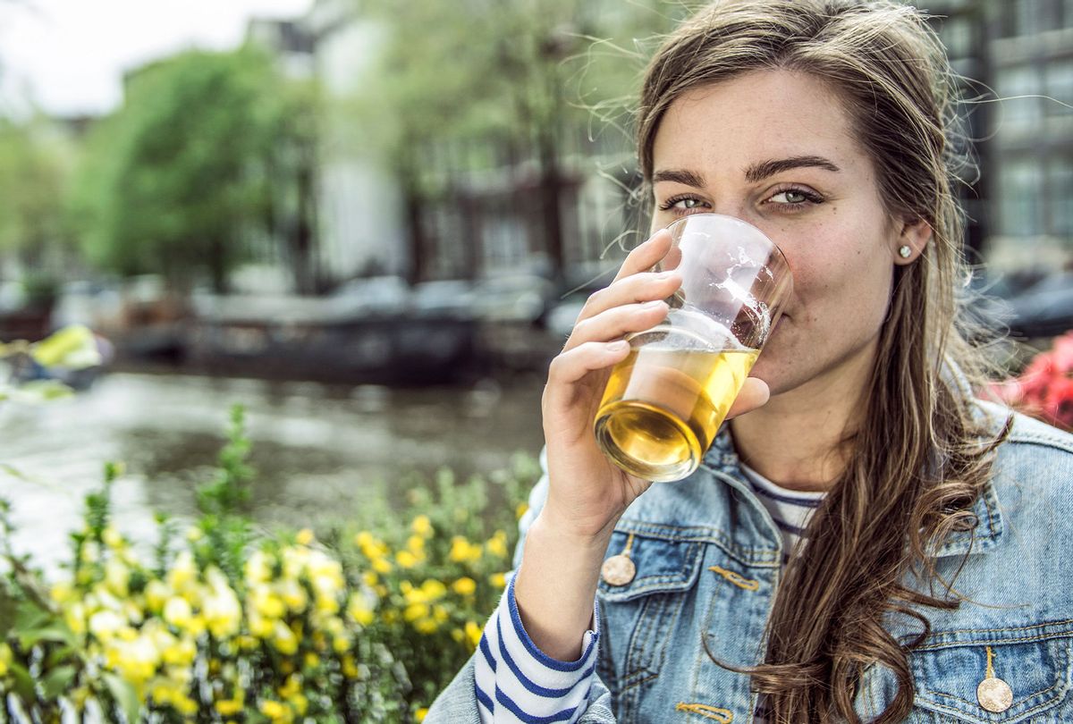 Woman drinking glass of beer (Getty Images)