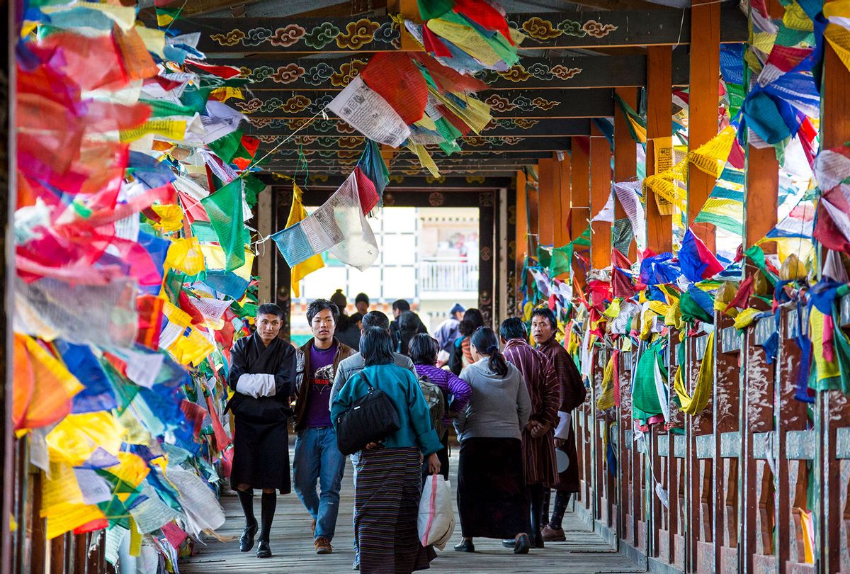 Local people passing a bridge to a marketplace, decorated with hundreds of prayer flags on November 18, 2012 in Thimphu, Bhutan. (EyesWideOpen/Getty Images)