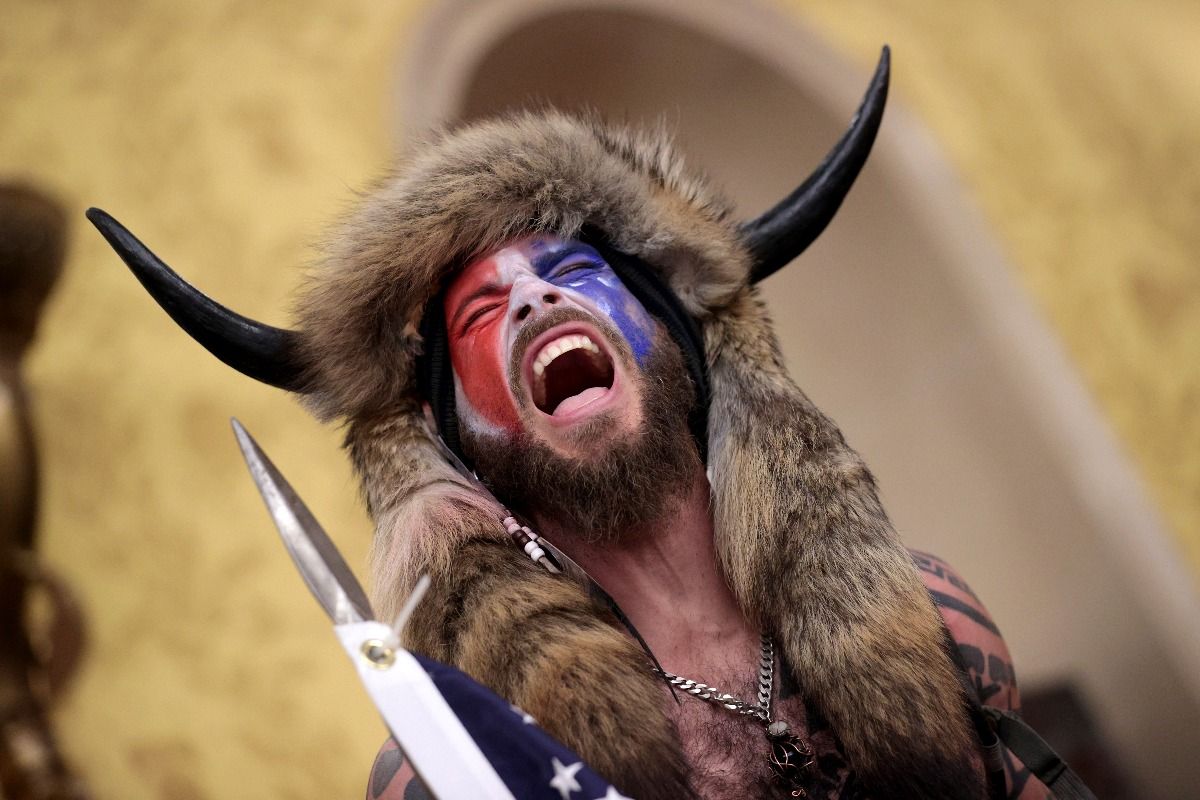 QAnon Shaman Jacob Chansley screams "freedom" inside the Senate chamber after the U.S. Capitol was breached by a mob during a joint session of Congress on January 06, 2021. (Win McNamee/Getty Image)
