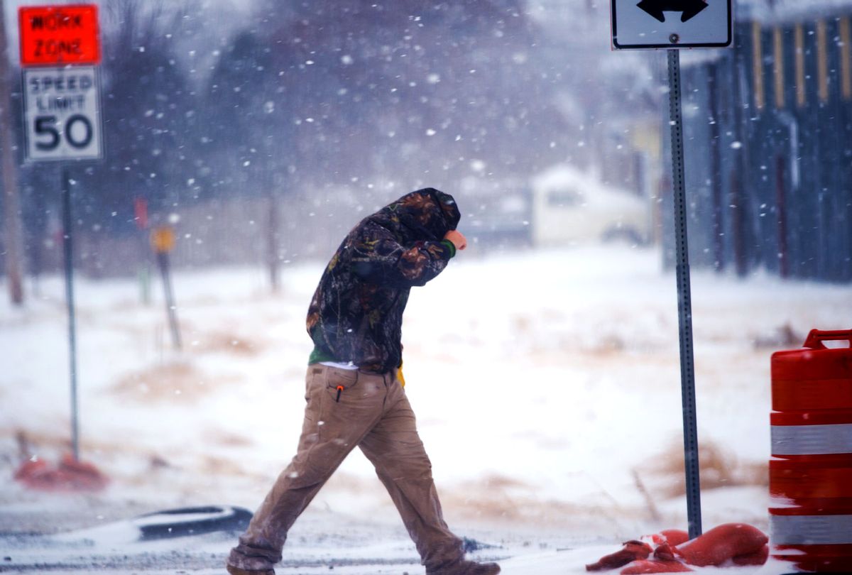 A highway worker tries to shield himself while walking to his truck in Lubbock, Texas.  (John Weast/Getty Images)