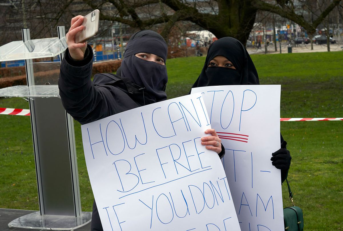 Two Muslim women wearing the niqab take a selfie during the demonstration against the law established by the government banning the use of the niqab in some public places in The Hague, Netherlands (Nacho Calonge/Getty Images)