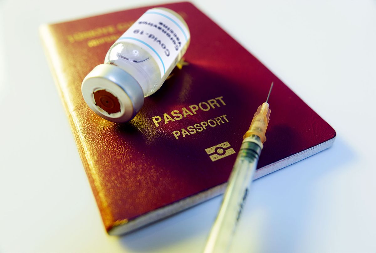 Coronavirus vaccine bottle with a Red-colored passport (Getty Images)