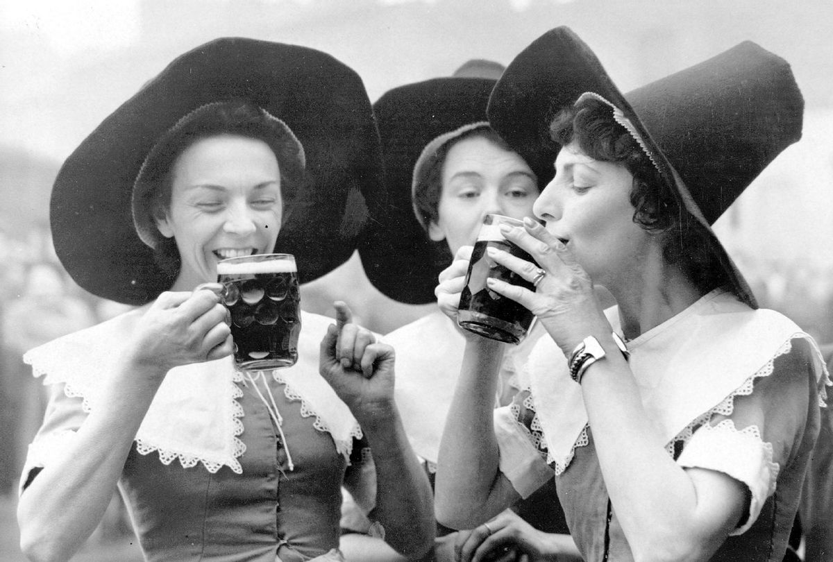 Alewives in costume sample ale at the site of the Festival Inn, Grundy Street, Poplar in anticipation of Festival of Britain, 1950 (Fox Photos/Getty Images)