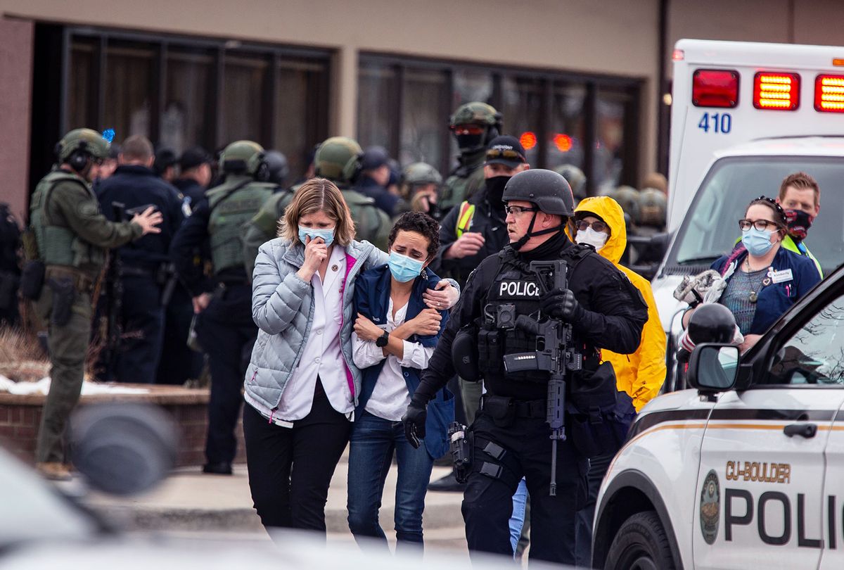 Healthcare workers walk out of a King Sooper's Grocery store after a gunman opened fire on March 22, 2021 in Boulder, Colorado. Dozens of police responded to the afternoon shooting in which at least one witness described three people who appeared to be wounded, according to published reports. (Chet Strange/Getty Images)
