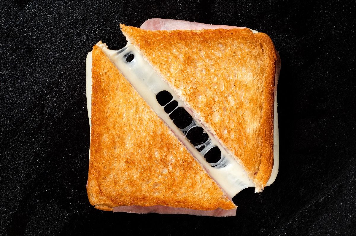 Classic cheese and ham sandwich on black cast iron griddle. (Getty Images)