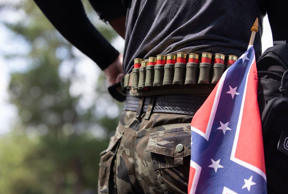 A man with ammunition can be seen in front of a confederate flag as members of far right militias and white pride organizations rally. (LOGAN CYRUS/AFP via Getty Images)