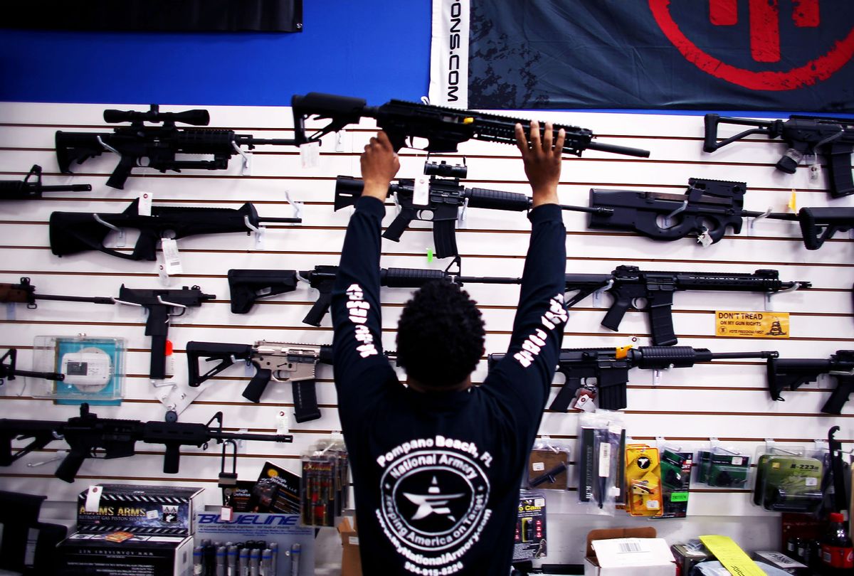 An employee puts a weapon on display at the National Armory gun store on April 11, 2013 in Pompano Beach, Florida.  (Joe Raedle/Getty Images)