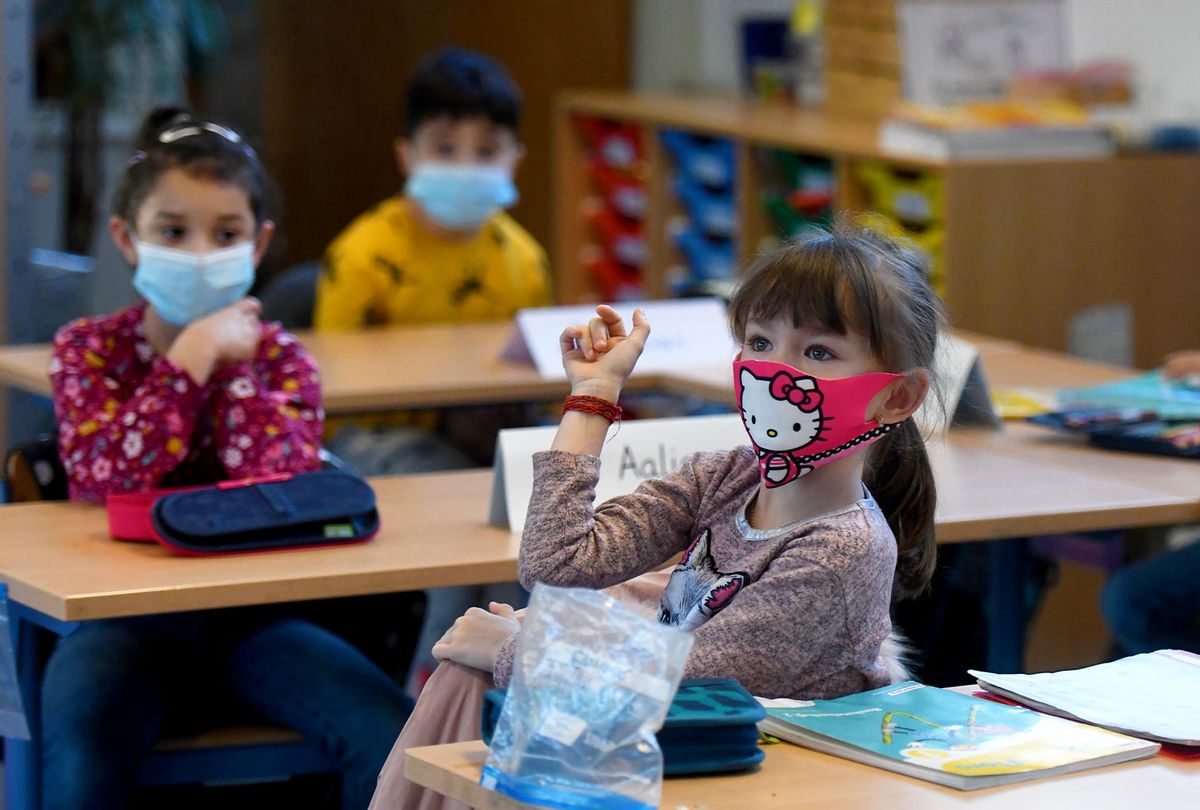 Second-grade pupils wear face masks as they attend school lessons (INA FASSBENDER/AFP via Getty Images)