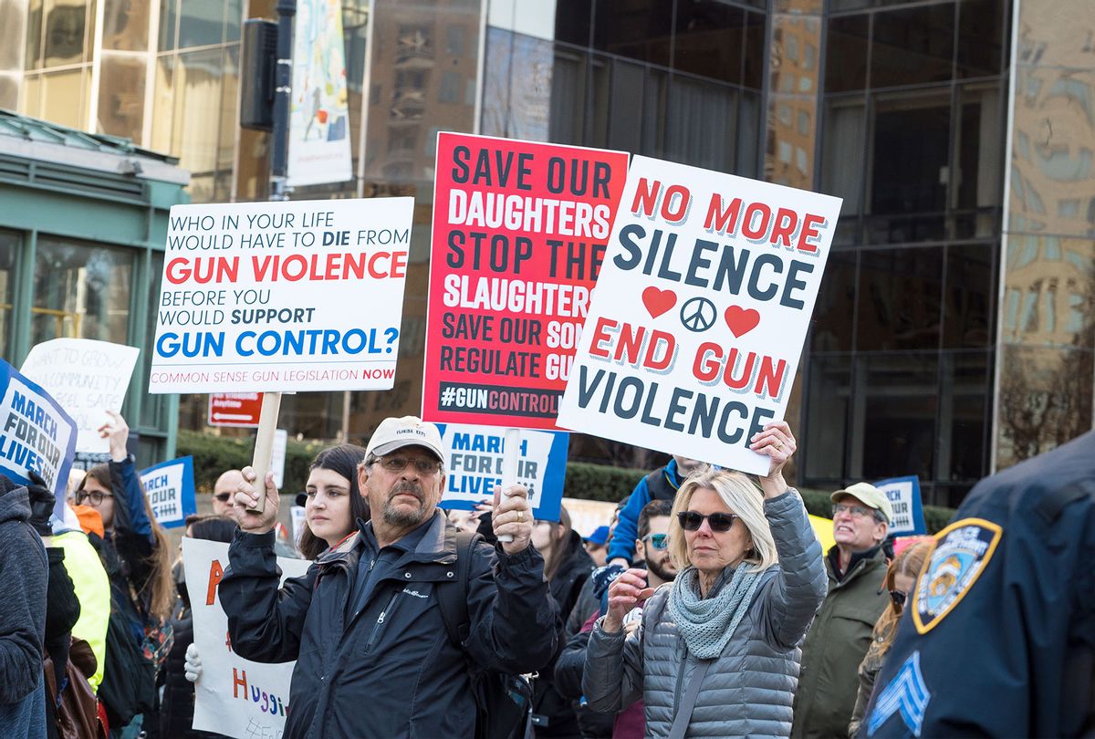 View of demonstrators, many with signs, as they participate in the March For Our Lives rally against gun violence, near Columbus Circle, New York, New York, March 24, 2018. Among the visible signs are ones that read 'Who Would Have to Die from Gun Violence Before You Would Support Gun Control?' and 'No More Silence End Gun Violence.' (Barbara Alper/Getty Images)