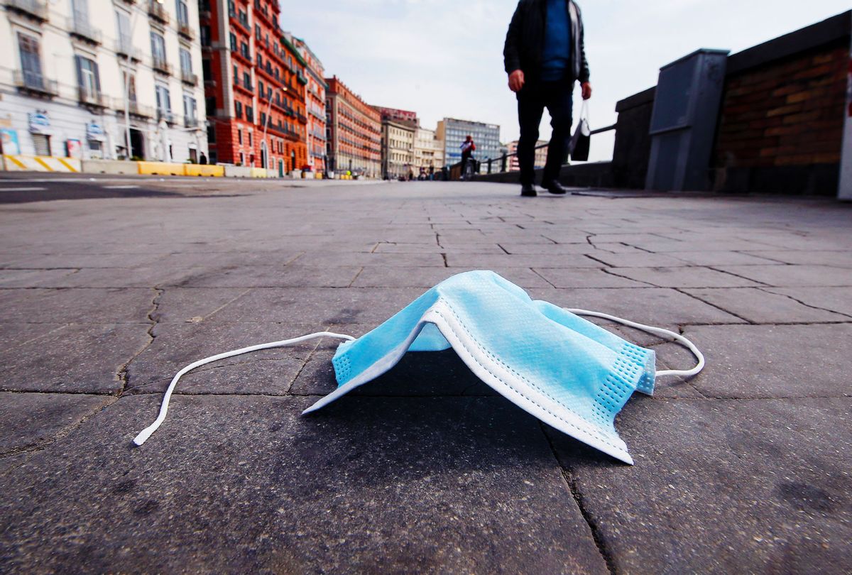 A worn-out mouth and nose protection mask lies thrown away on the street (Salvatore Laporta/KONTROLAB/LightRocket via Getty Images)