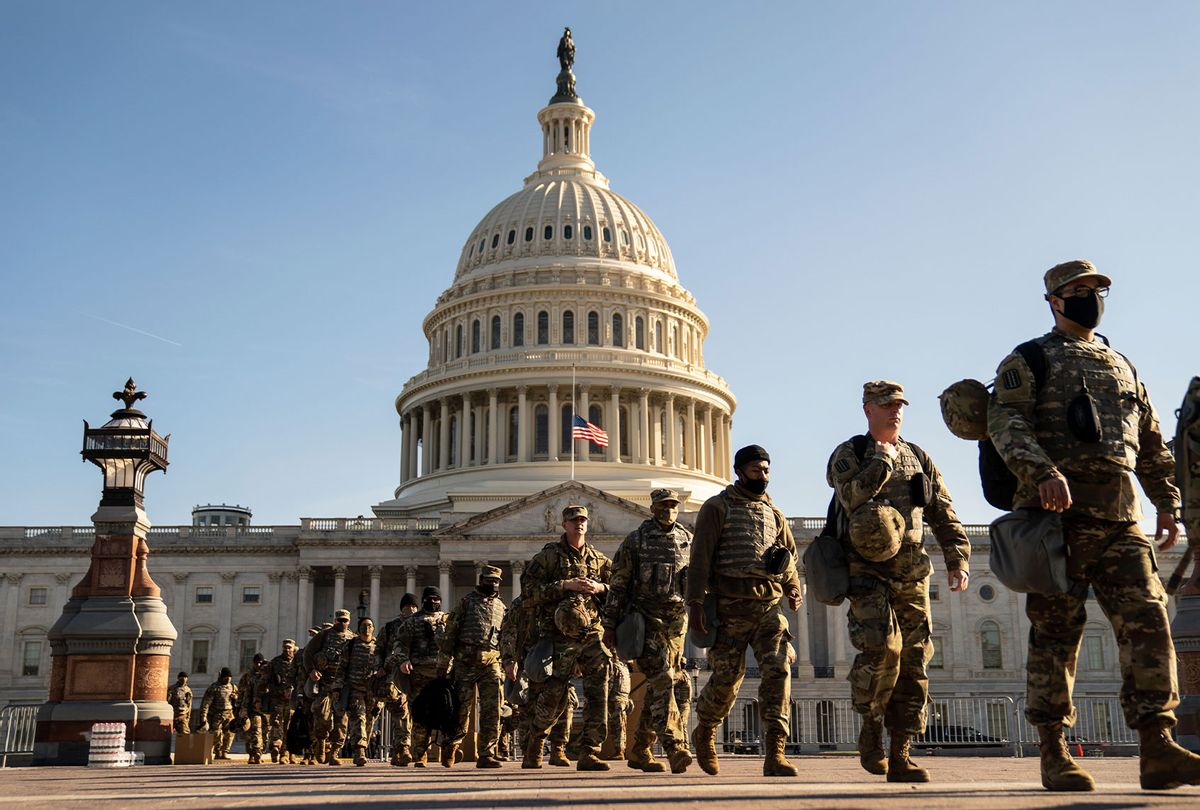 Members of the National Guard, outside the U.S. Capitol Building a day after the House of Representatives impeached President Donald Trump, and over a week after a pro-Trump insurrectionist mob breached the security of the nations capitol on Thursday, Jan. 14, 2021 in Washington, DC. An estimated 20,000 National Guard troops are expected to be deployed to the city to support law enforcement around three times the total number of American troops deployed abroad in Iraq, Afghanistan, Somalia and Syria. (Kent Nishimura / Los Angeles Times via Getty Images)