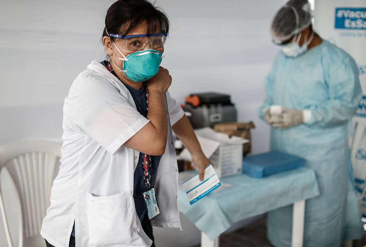 A health worker after her vaccination against Covid-19 with the Chinese company Sinopharm's Vero vaccine at Edgardo Rebagliati Hospital in Lima, Peru. In early February, the South American country received the first shipment of 300,000 doses of the Chinese Corona vaccine. Sinopharm had already collaborated with Peru in the practical testing phase of the vaccine. (Alex Rosemberg/picture alliance via Getty Images)
