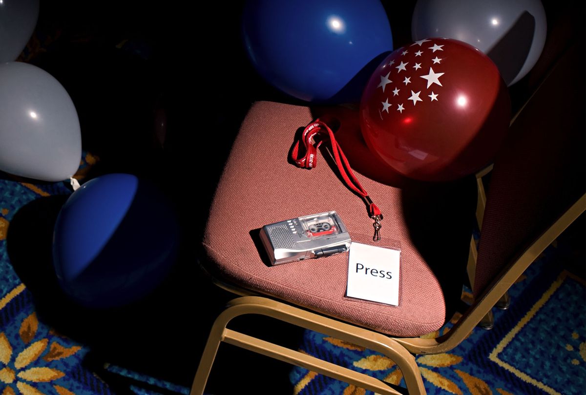A press pass and tape recorder on a chair (Getty Images)