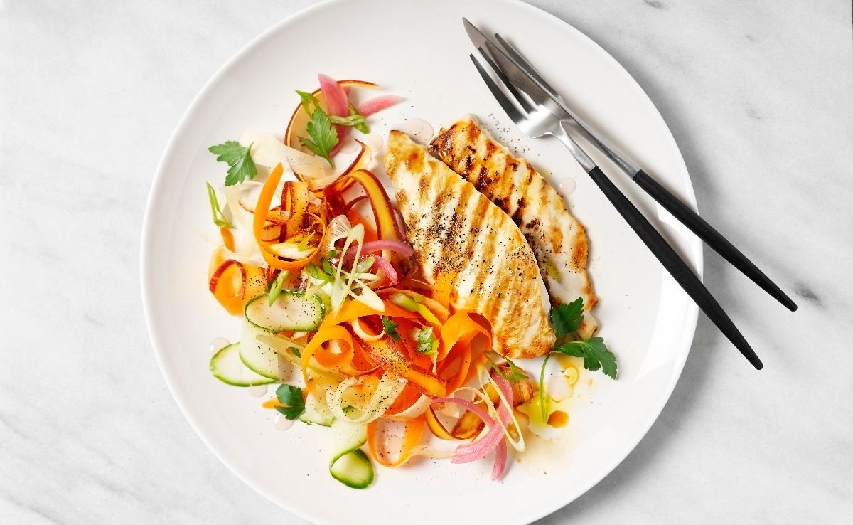 A plate of grilled chicken with carrot salad. (Getty Images)