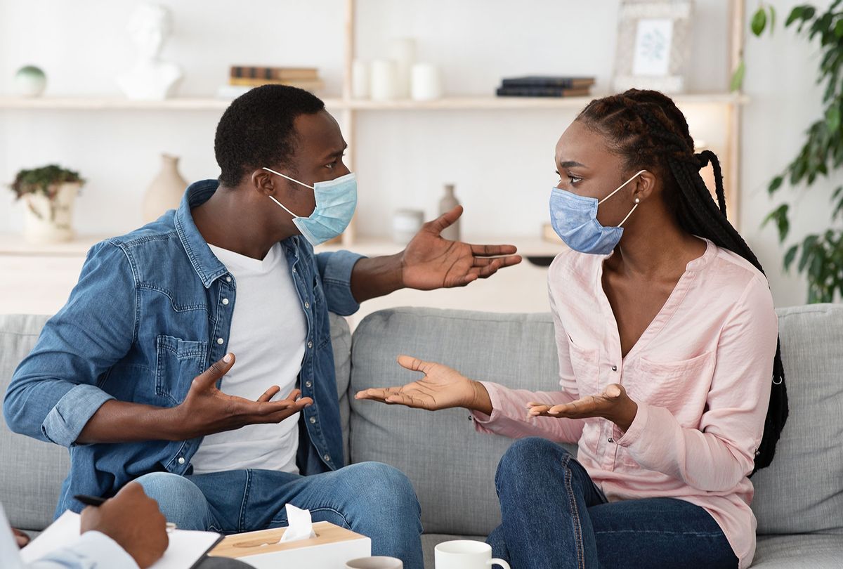 Couple in medical masks arguing (Getty Images)