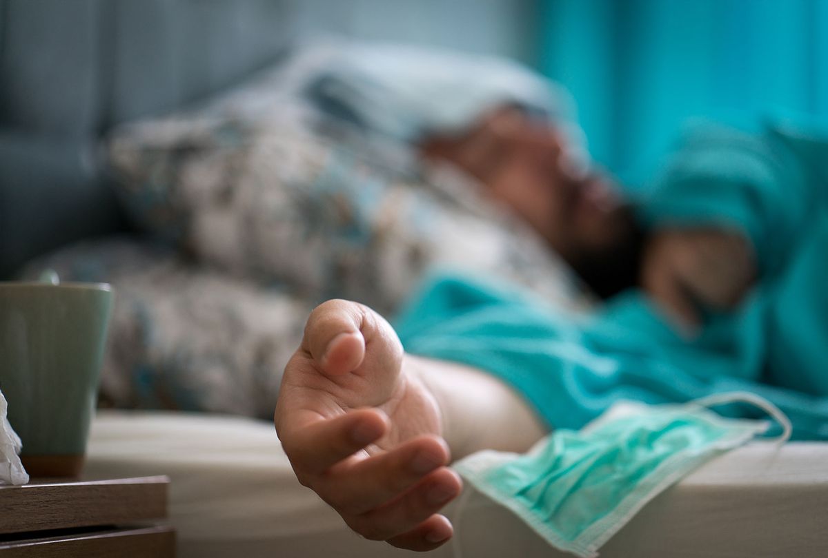 Sick man with covid-19 symptoms in bed (Getty Images)