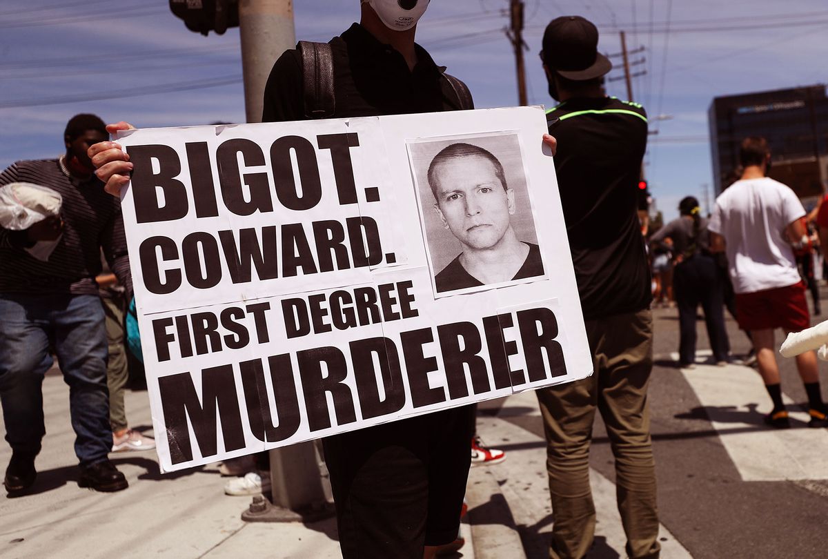 A protester holds a sign with a photo of former Minneapolis police officer Derek Chauvin during demonstrations following the death of George Floyd on May 30, 2020 in Los Angeles, California. Chauvin was taken into custody for Floyd's death. Chauvin has been accused of kneeling on Floyd's neck as he pleaded with him about not being able to breathe. Floyd was pronounced dead a short while later. Chauvin and 3 other officers, who were involved in the arrest, were fired from the police department after a video of the arrest was circulated. (Mario Tama/Getty Images)