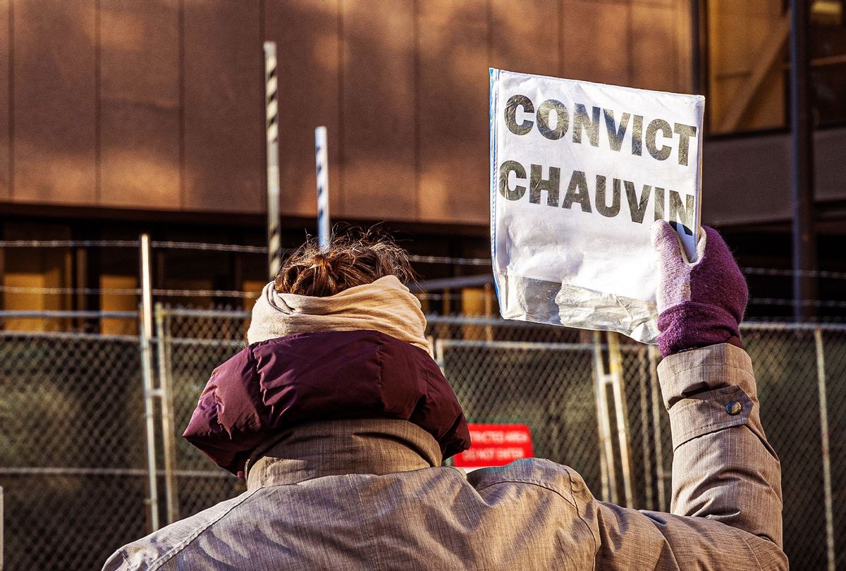 A woman protests outside the Hennepin County Government Center, where the trial of former police officer Derek Chauvin is being held, on March 31, 2021 in Minneapolis, Minnesota. - A store clerk said on March 31 at the trial of former Minneapolis police officer Derek Chauvin that he regretted accepting the fake $20 bill from George Floyd that led to his arrest and eventual death. "If I would have just not taken the bill, this could have been avoided," Christopher Martin said on the third day of Chauvin's high-profile trial. (KEREM YUCEL/AFP via Getty Images)